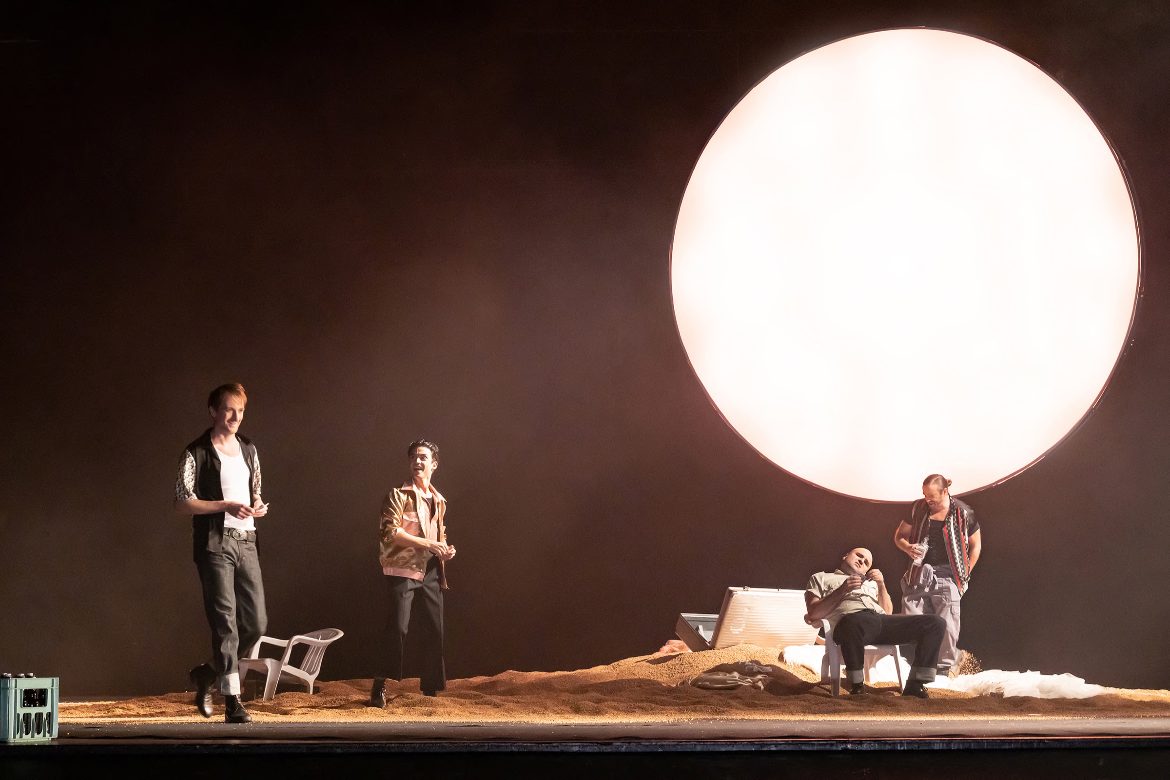 Stage with a glowing moon and four actors