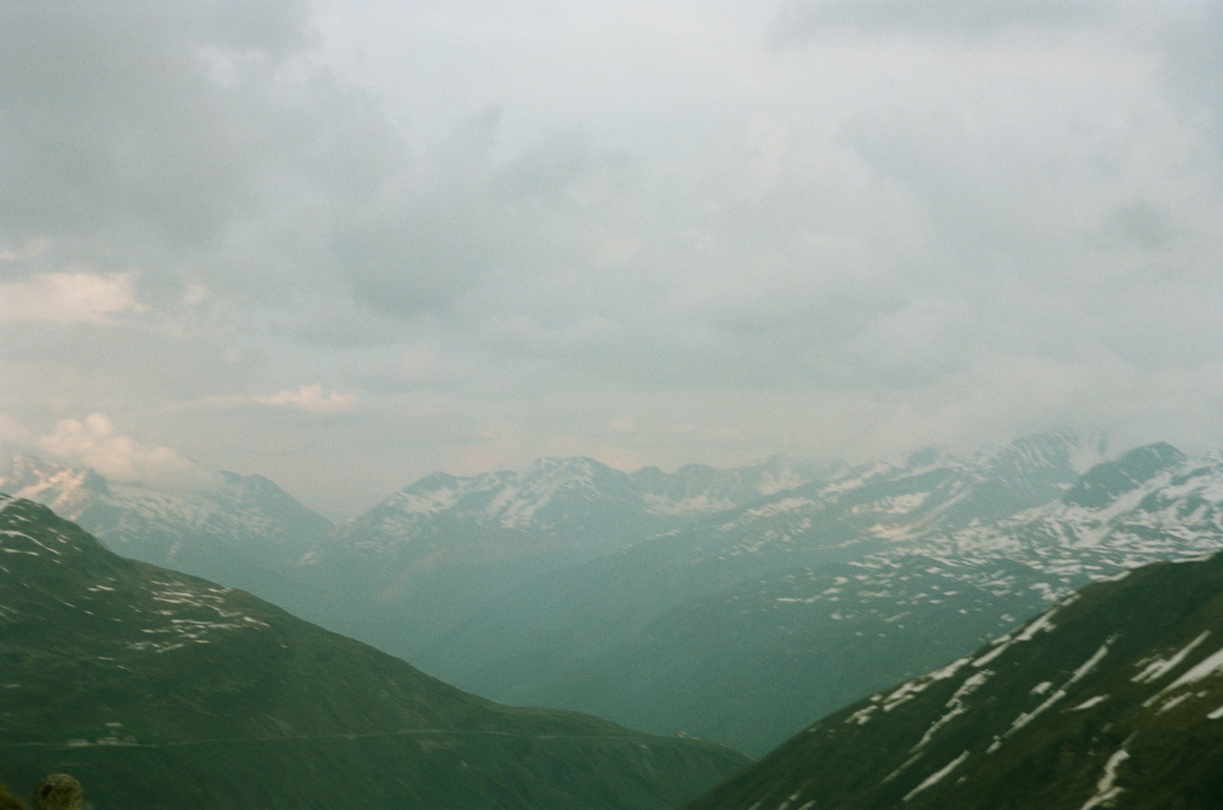Alpine valley with snow under cloud