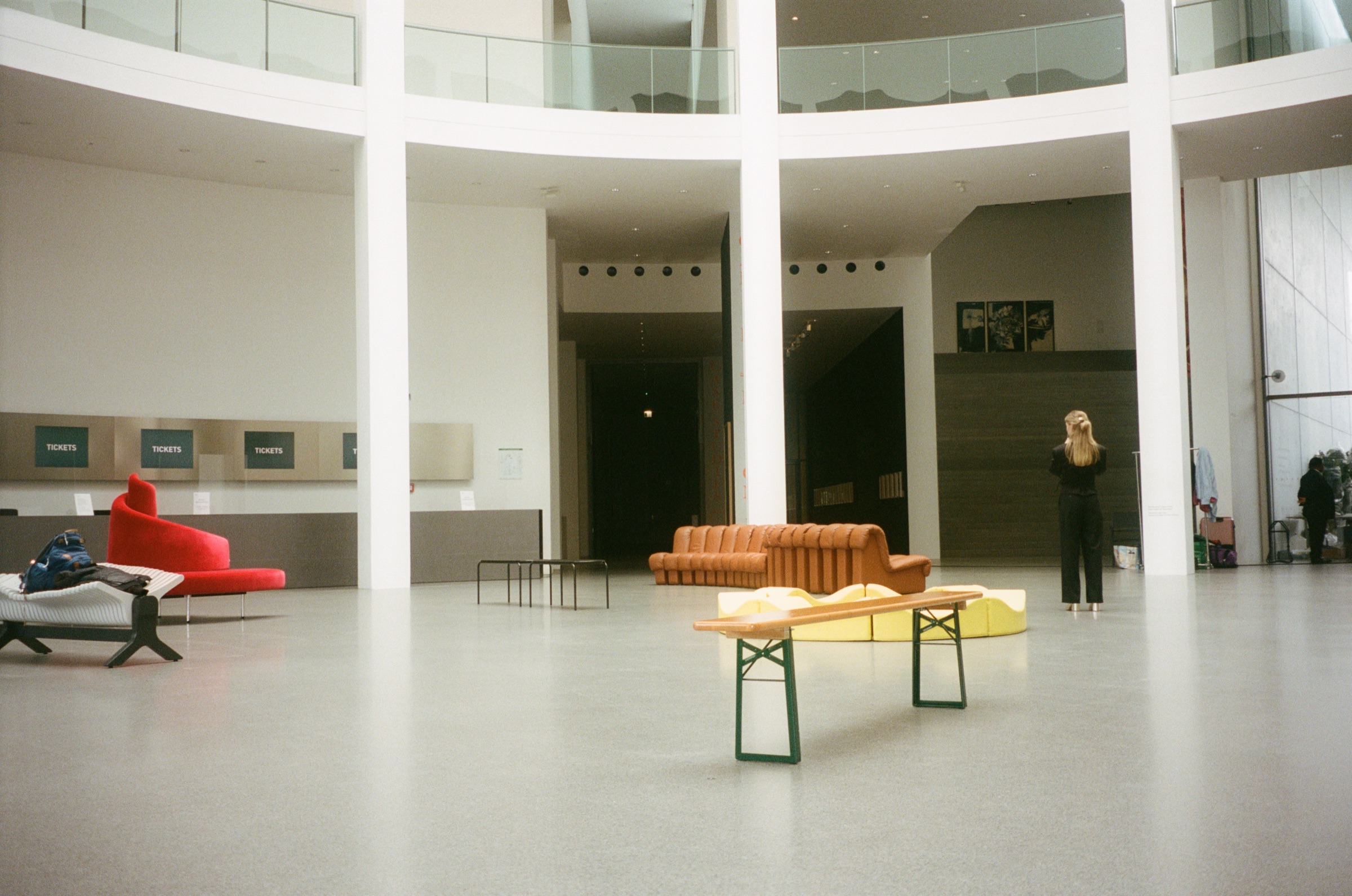 The white rotunda of a museum with a red sofa