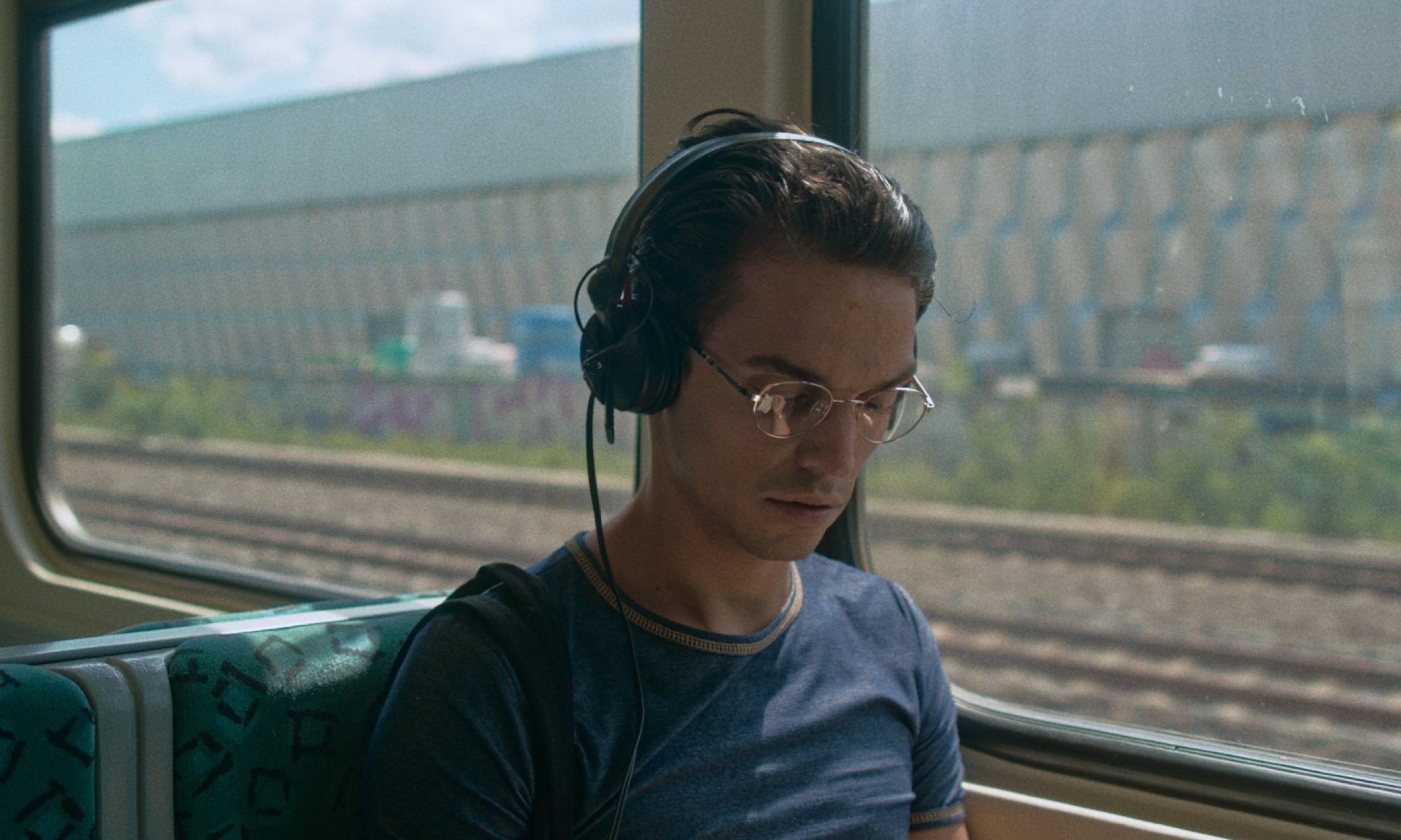 Young man with headphones on a train