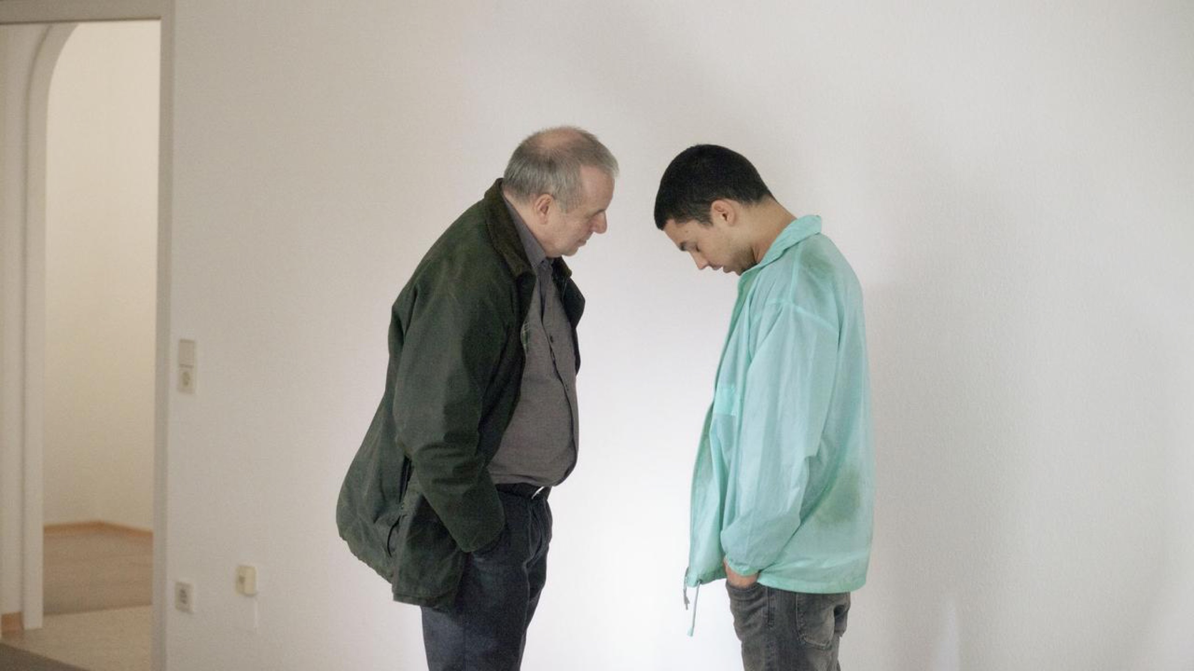 Two men face to face in an empty room