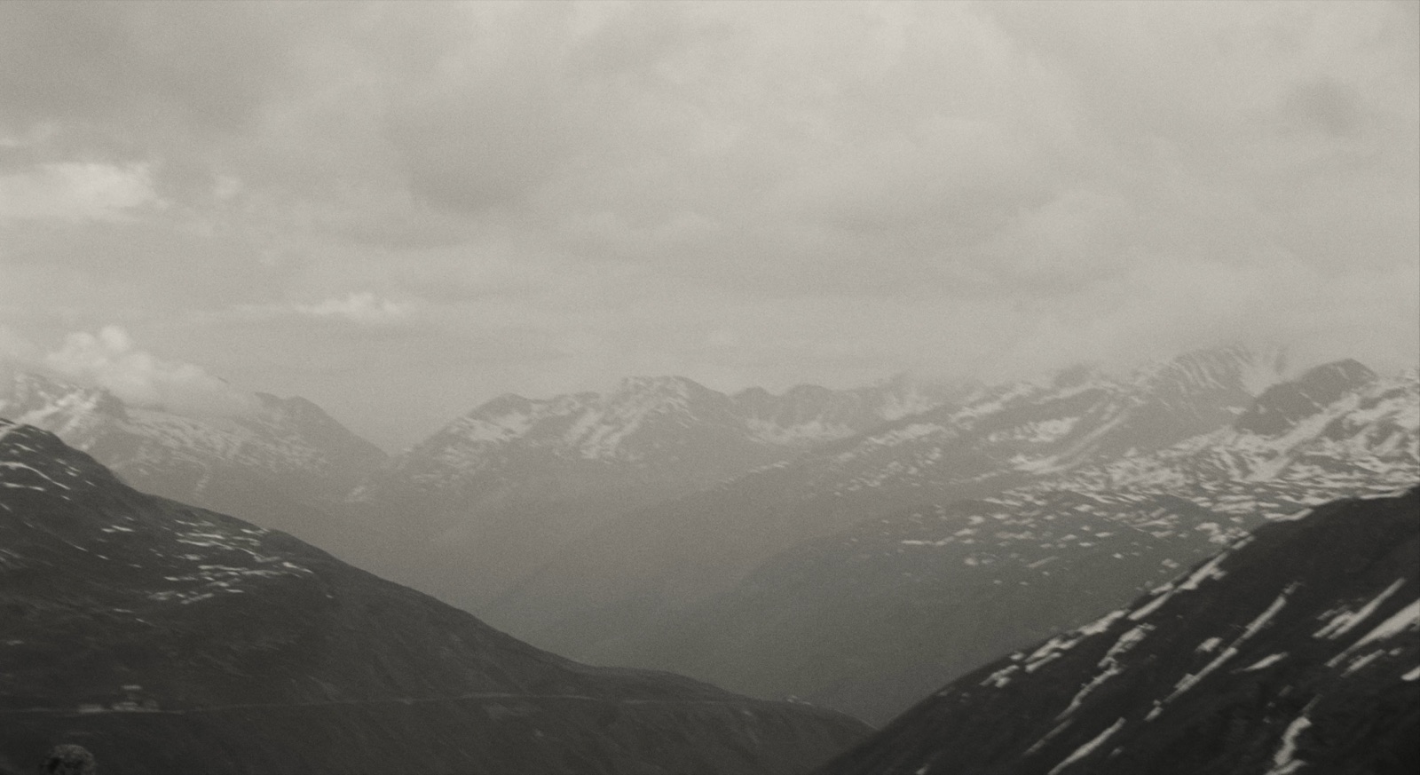 Projection still: an Alpine valley in sepia